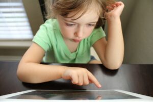 Young child using AAC to communicate in the classroom